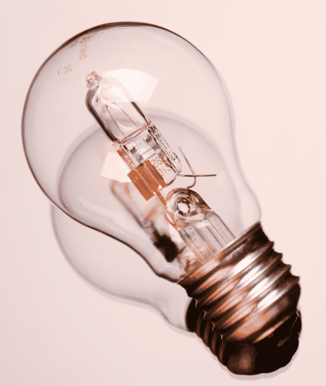 Incandescent light bulb on pink background 